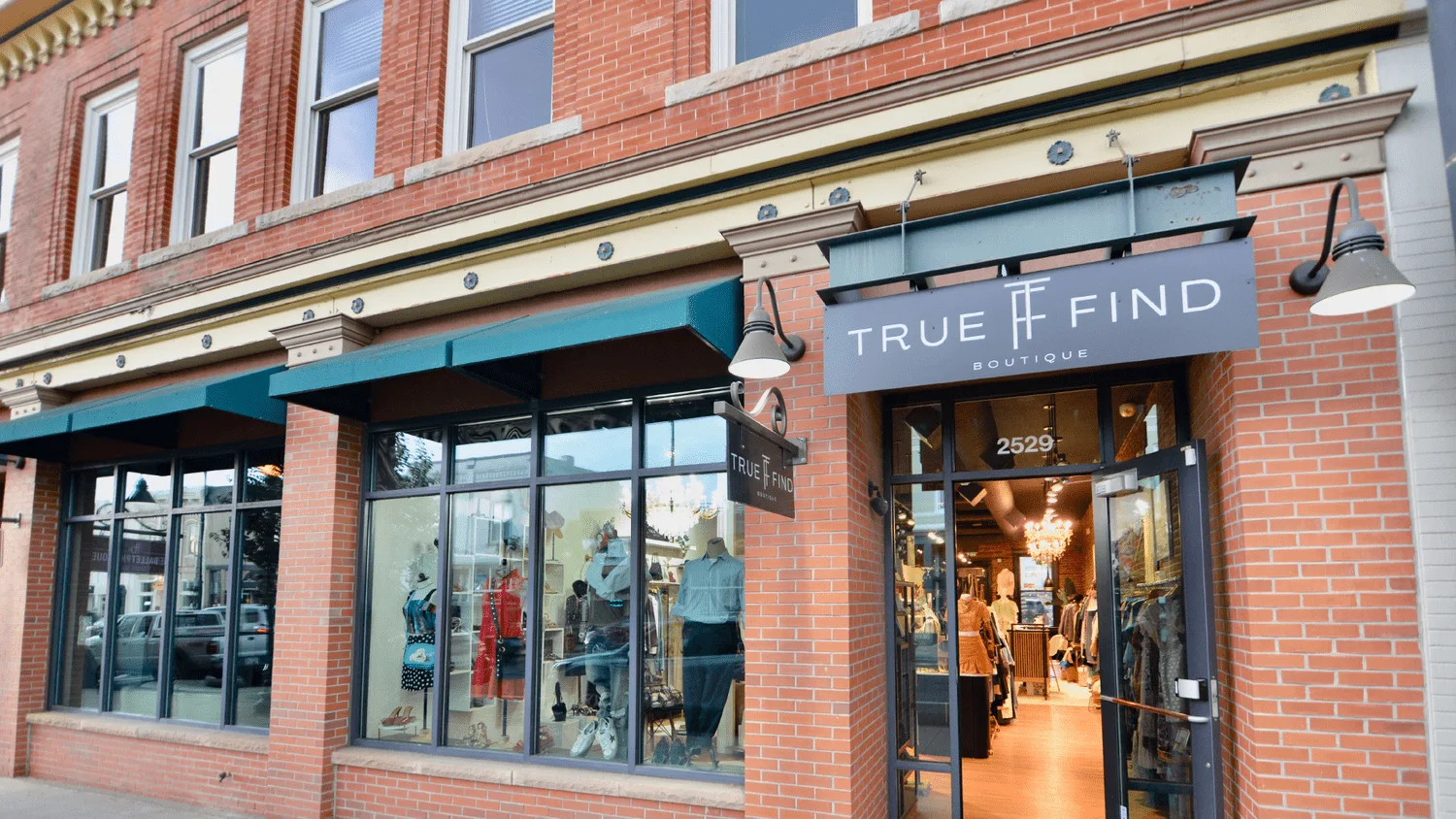 True Find Boutique storefront with brick facade and large display windows at 2529
